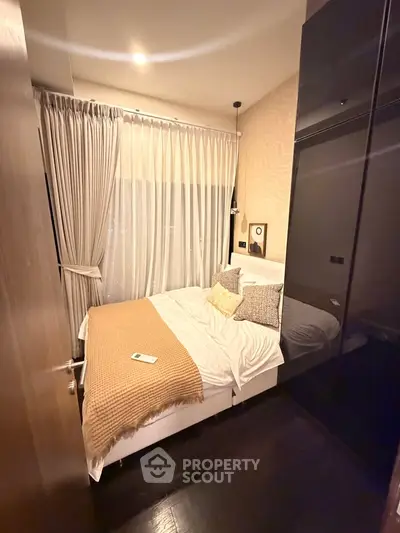 Cozy bedroom with elegant decor, featuring a plush bed, stylish curtains, and warm lighting for a serene ambiance.
