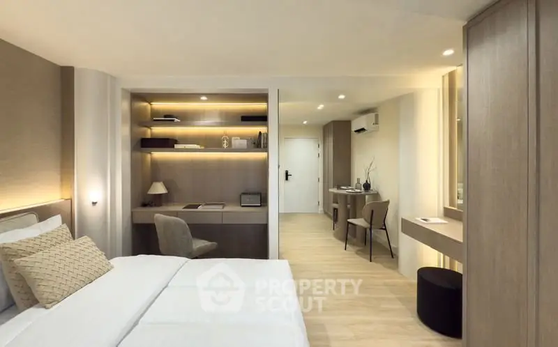 Luxurious modern bedroom with elegant decor and built-in study area, perfect for comfort and productivity.