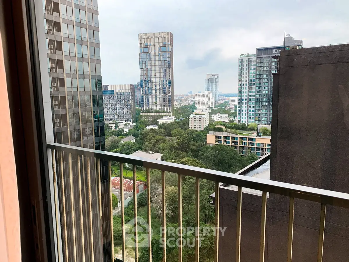 Stunning cityscape view from a high-rise balcony overlooking lush greenery and modern skyscrapers.