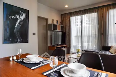 Modern living room with dining area, stylish decor, and large windows for natural light.