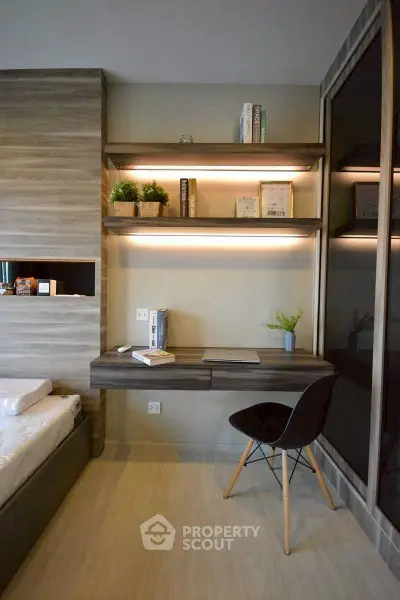 Modern bedroom with stylish study area and built-in shelves