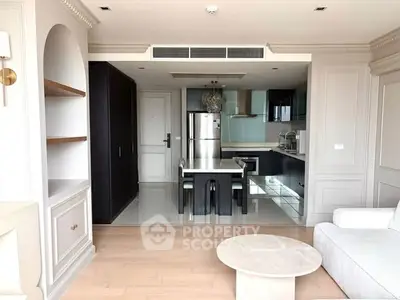 Modern open-plan living room with sleek kitchen and dining area, featuring elegant cabinetry and contemporary design.
