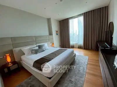 Luxurious bedroom with elegant decor and city view, featuring a king-size bed and modern furnishings.