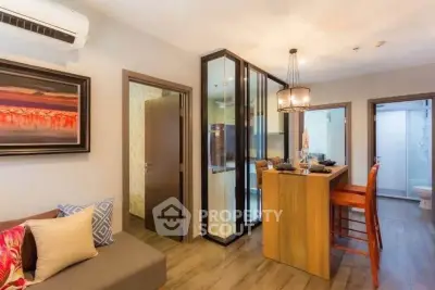 Modern living room with stylish decor and open kitchen layout in a cozy apartment.