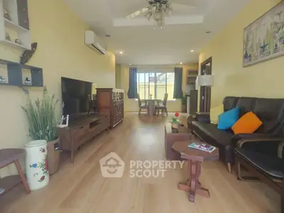 Spacious living room with modern decor and wooden flooring