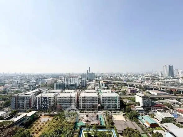 Stunning panoramic city view from high-rise apartment balcony showcasing urban landscape.