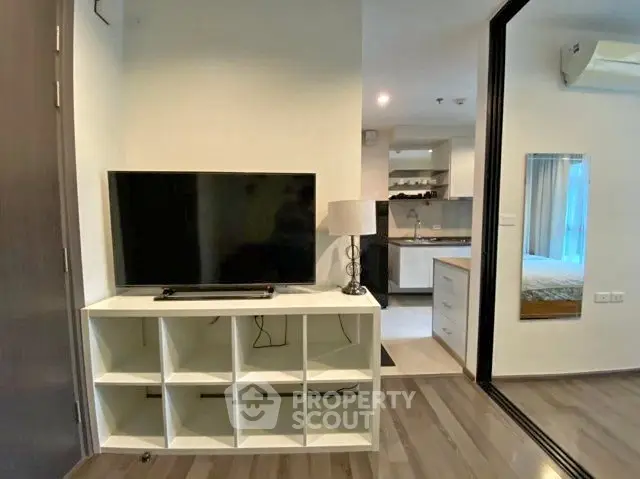 Modern apartment interior with open layout, featuring a cozy living area and sleek kitchen design.