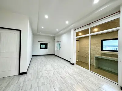 Spacious modern living room with large windows and sleek flooring
