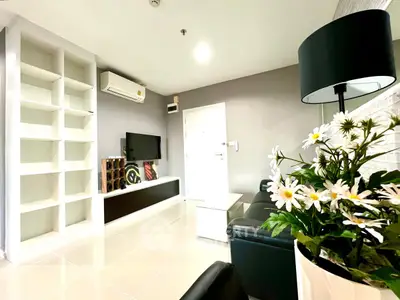 Modern living room with sleek furniture and built-in shelving, perfect for stylish urban living.