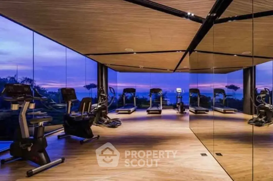 Luxurious gym with panoramic views and modern equipment in upscale real estate property.