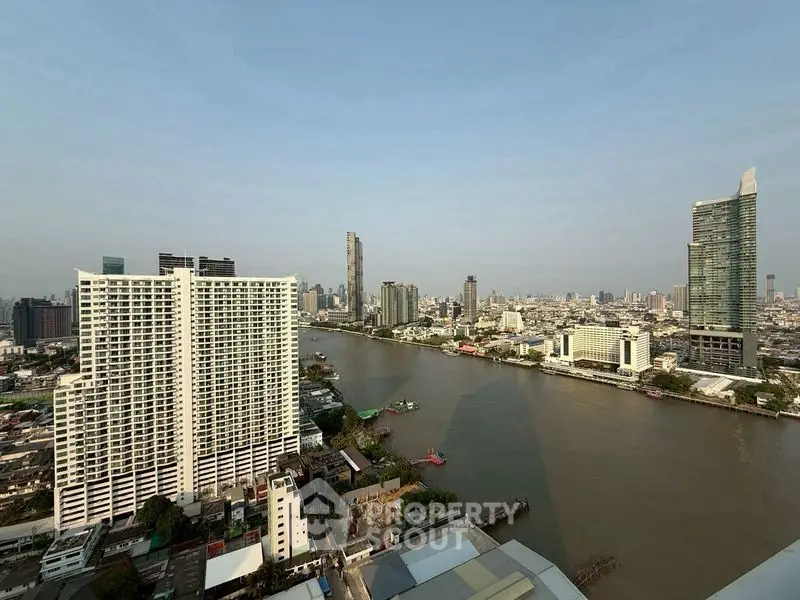 Stunning river view from high-rise apartment in bustling cityscape
