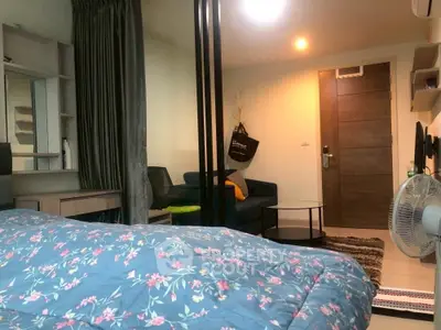 Cozy studio apartment with modern decor and floral bedding, perfect for urban living.