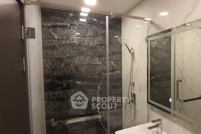 Luxurious bathroom with modern shower and elegant marble walls