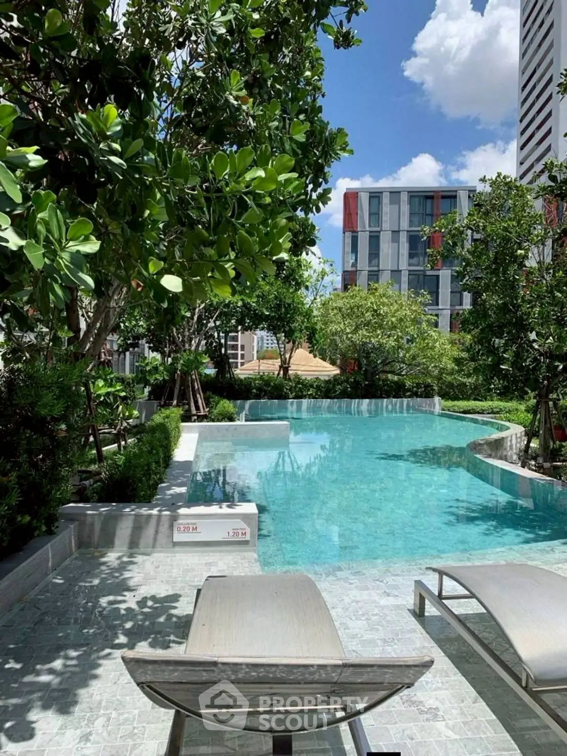 Luxurious outdoor pool area with lush greenery and modern architecture