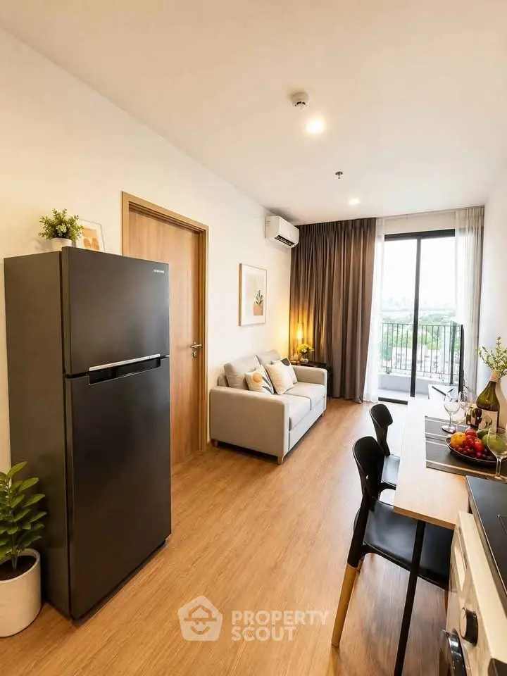 Modern living room with balcony, stylish decor, and open layout featuring a sleek black fridge and dining area.