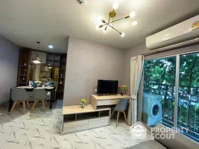 Modern living room with balcony and washing machine, stylish decor and open dining area.