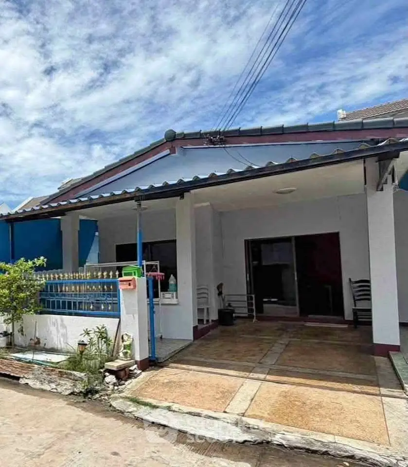 Charming single-story home with covered carport and inviting entrance in a serene neighborhood.