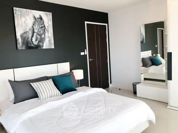 Modern bedroom with stylish decor and large mirror