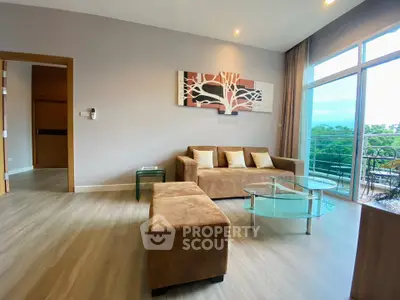 Spacious living room with modern decor and large windows offering a scenic view.
