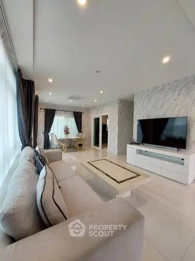 Luxurious modern living room with elegant decor and large flat-screen TV