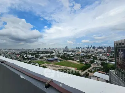 Stunning cityscape view from a high-rise building rooftop, showcasing expansive urban skyline and lush greenery.