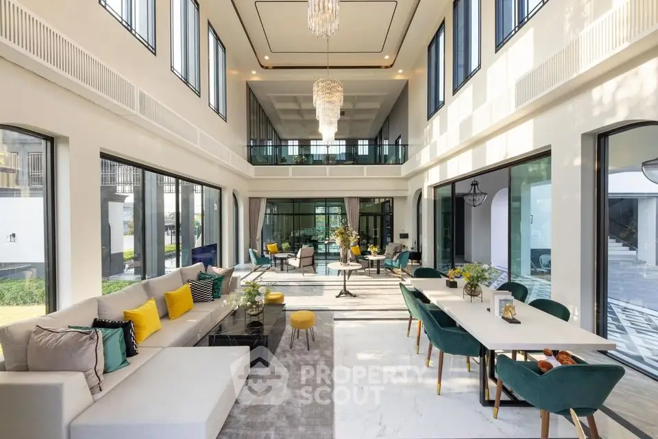 Luxurious double-height living room with elegant decor and large windows