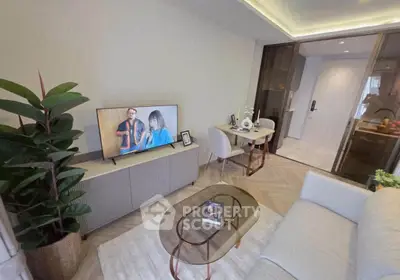 Modern living room with stylish decor and open layout, featuring a cozy seating area and sleek TV setup.