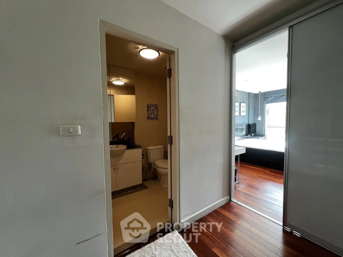 Modern apartment with wooden flooring and compact bathroom