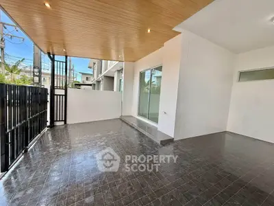 Spacious modern balcony with sleek tile flooring and wooden ceiling