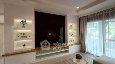 Elegant living room with modern built-in shelves and large window for natural light