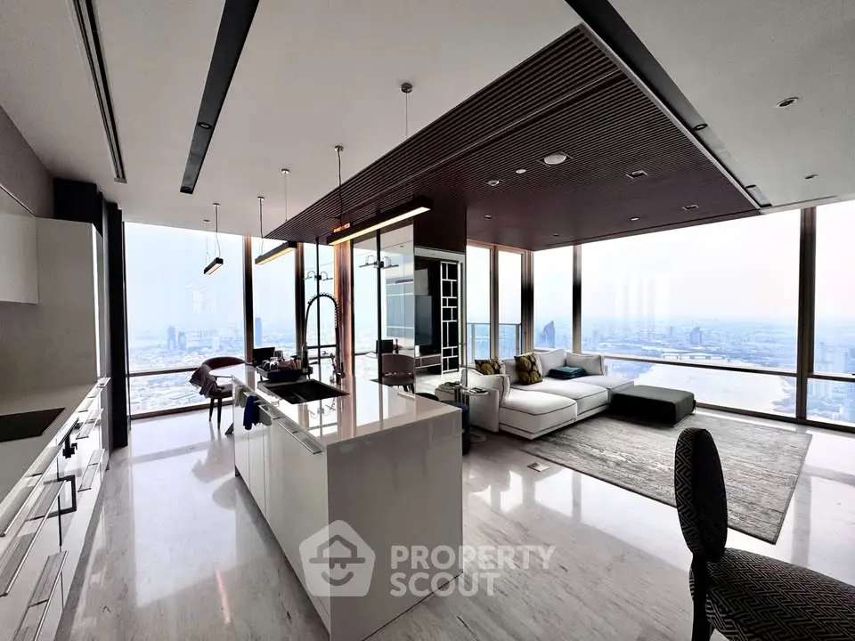 Luxurious open-plan living room with panoramic city views and modern kitchen island.