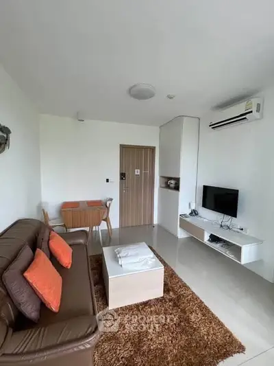 Modern living room with sleek furniture and air conditioning in a cozy apartment.