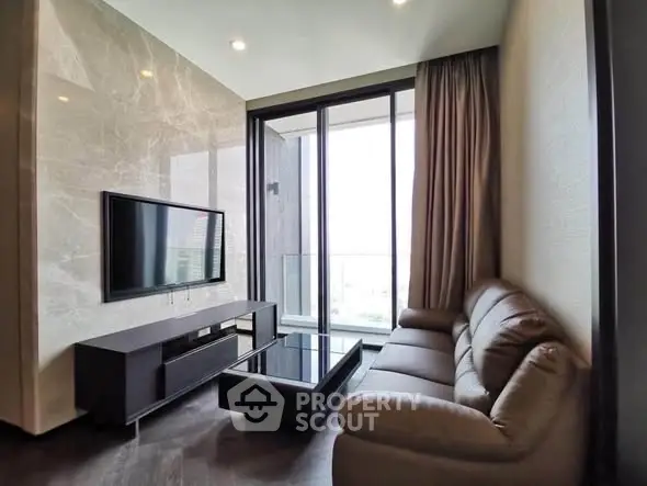 Modern living room with sleek furniture and large windows offering a stunning view.