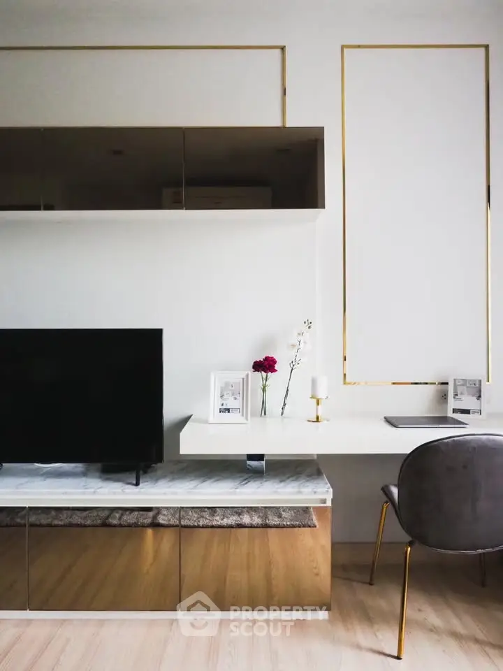 Modern living room with sleek furniture and elegant decor, featuring a wall-mounted TV and stylish shelving.