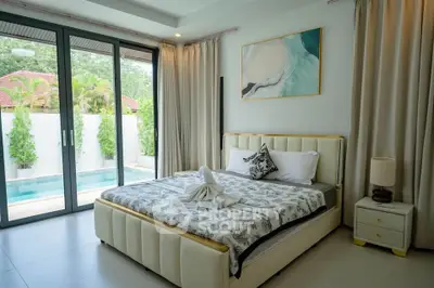 Luxurious bedroom with pool view and elegant decor in modern home