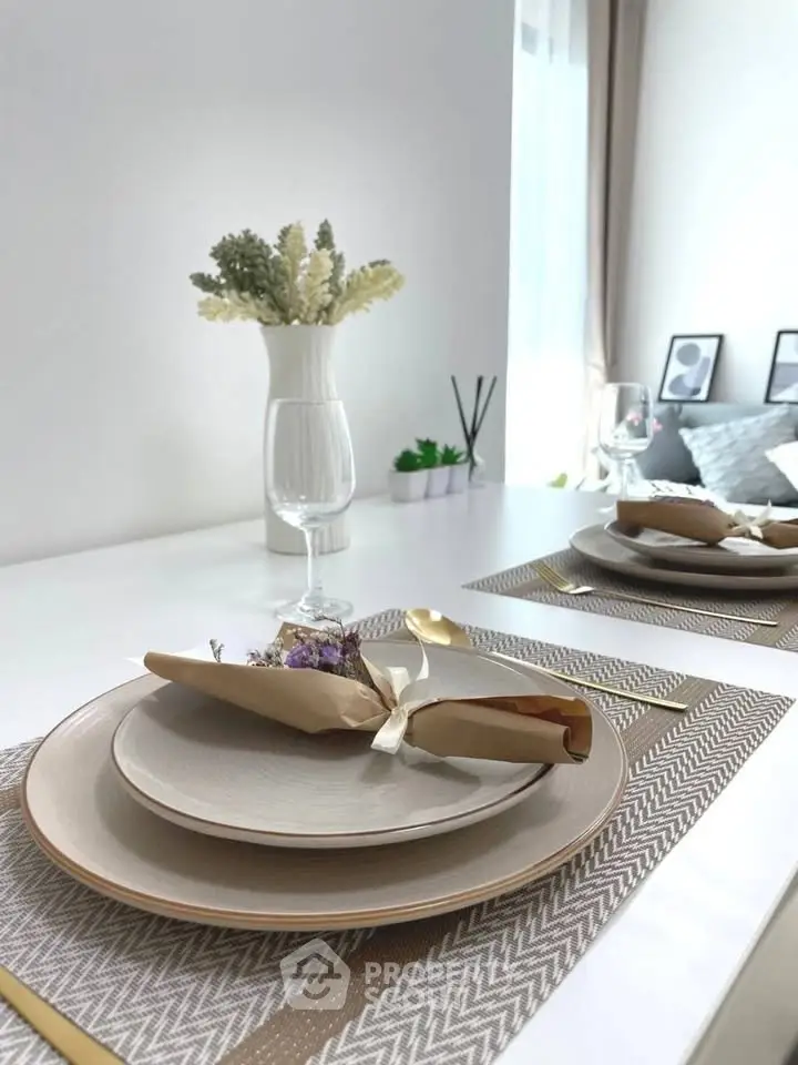Elegant dining setup with modern tableware and decor in a bright interior.