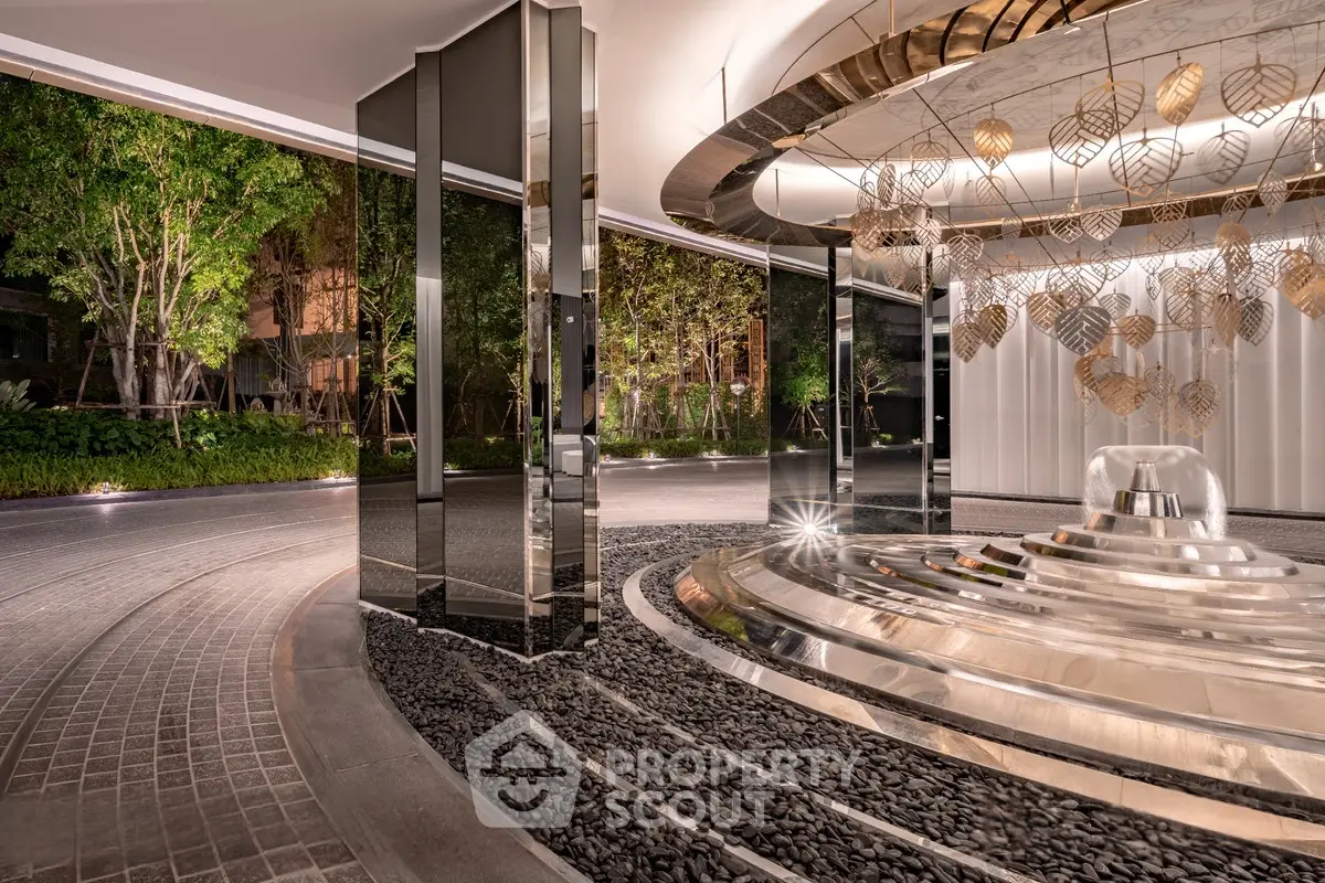 Luxurious building entrance with modern design and elegant lighting, showcasing a sophisticated ambiance.