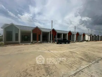 Modern row of newly constructed townhouses with unique architectural design and spacious driveways.