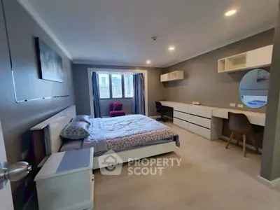 Spacious modern bedroom with elegant decor and ample natural light