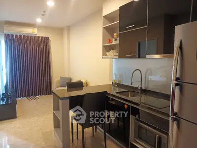 Modern open-layout kitchen with sleek appliances and cozy living area