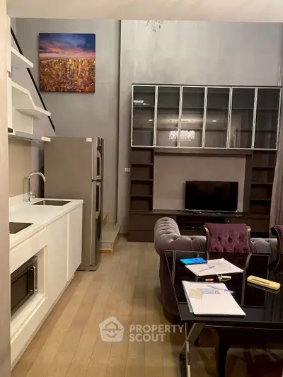 Modern living room with sleek kitchen, stylish furniture, and elegant shelving, perfect for urban living.