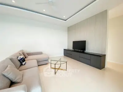 Spacious modern living room with sleek furniture and minimalist design.