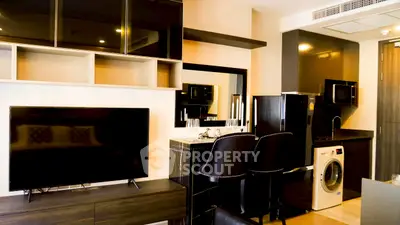 Modern living room with sleek kitchen appliances and stylish decor