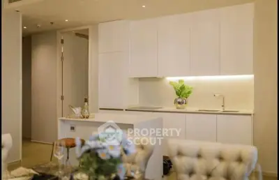 Modern kitchen with sleek white cabinets and elegant dining setup