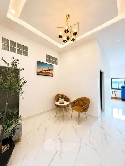 Elegant modern living room with chic chandelier and stylish seating area, perfect for relaxation and entertaining.