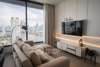 Luxurious living room with stunning city and river view, modern decor and cozy seating area.