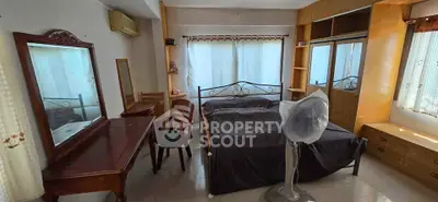 Spacious bedroom with elegant wooden furniture and natural light