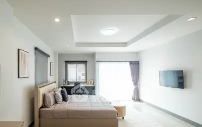 Spacious modern bedroom with elegant decor and natural light