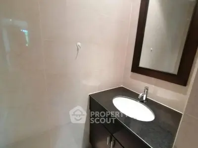 Modern bathroom with sleek vanity and elegant mirror