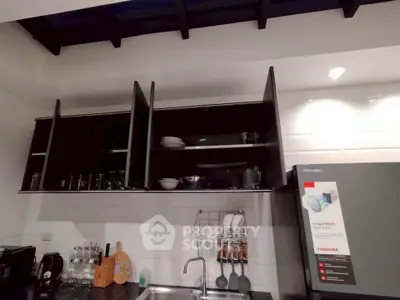 Modern kitchen with sleek cabinets and appliances, featuring a stylish open layout and contemporary design.